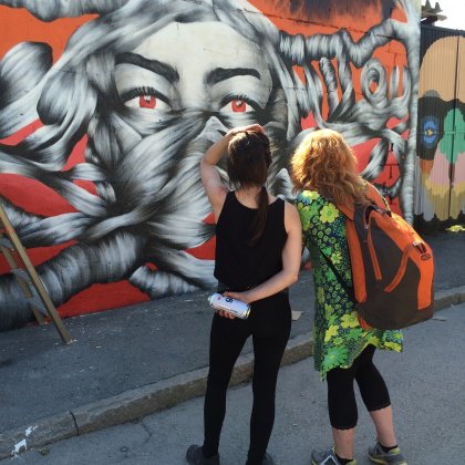 Cool female street artist checking her work